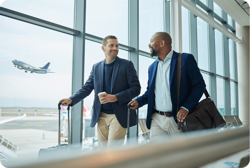 Two men talking with luggage at airport
